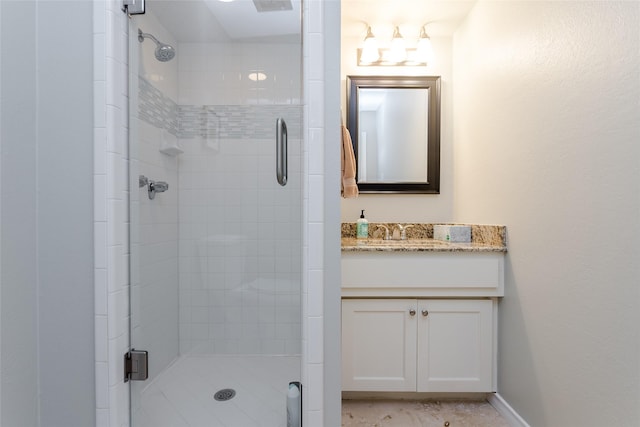 bathroom with an enclosed shower and vanity