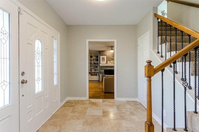 foyer entrance featuring a large fireplace