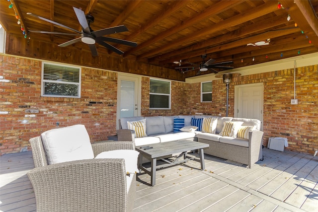 wooden terrace with an outdoor hangout area and ceiling fan