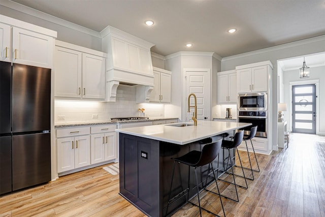 kitchen featuring stainless steel appliances, sink, and white cabinets