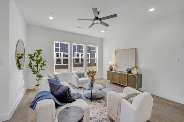 living room with hardwood / wood-style flooring and ceiling fan