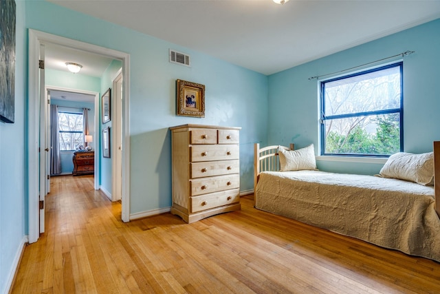 1241 Cypress Dr, Richardson, TX 75080 - bedroom with visible vents, light wood-style flooring, and baseboards