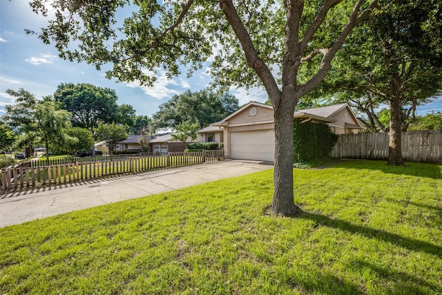1241 Cypress Dr, Richardson, TX 75080 - view of yard featuring a fenced front yard, an attached garage, and driveway