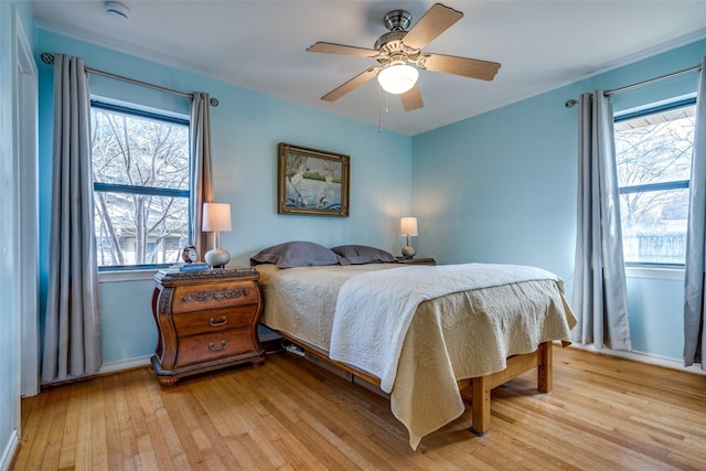 1241 Cypress Dr, Richardson, TX 75080 - bedroom featuring light wood finished floors, multiple windows, and ceiling fan
