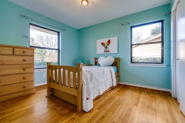 1241 Cypress Dr, Richardson, TX 75080 - bedroom featuring baseboards and light wood finished floors