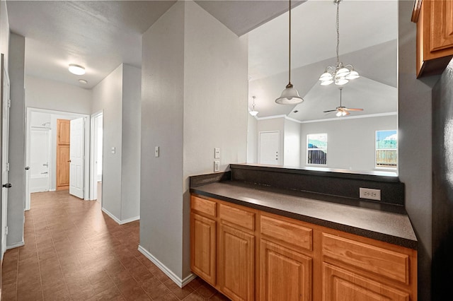 kitchen with decorative light fixtures, vaulted ceiling, and ceiling fan