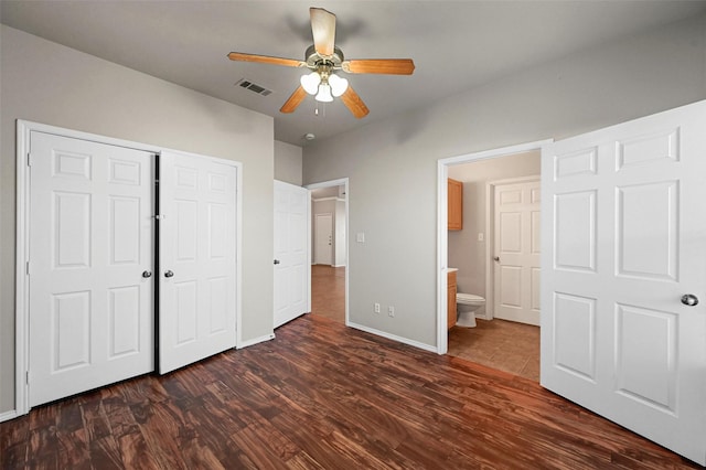 unfurnished bedroom with ceiling fan, dark hardwood / wood-style flooring, and a closet