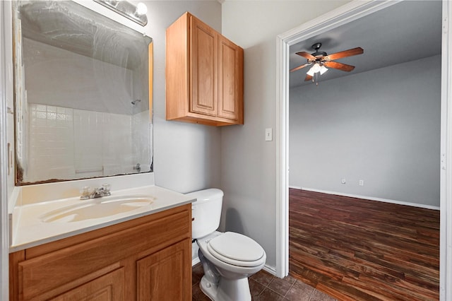 bathroom featuring a shower, vanity, ceiling fan, toilet, and tile patterned floors