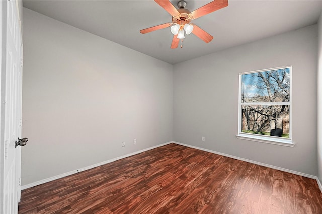 empty room featuring dark wood-type flooring and ceiling fan