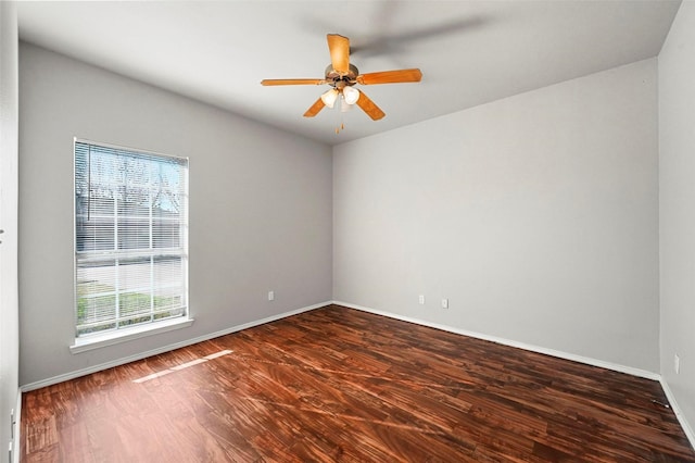 spare room featuring ceiling fan and dark hardwood / wood-style floors