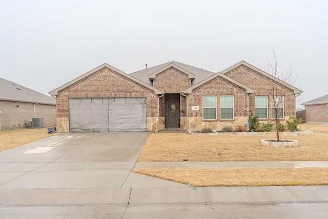 ranch-style house with a garage and central AC