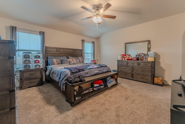 bedroom with lofted ceiling, light colored carpet, and ceiling fan