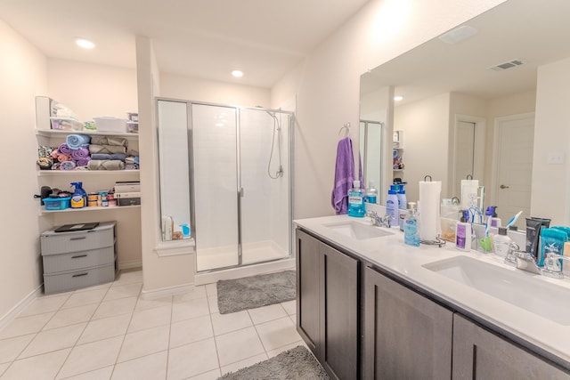 bathroom featuring walk in shower, vanity, and tile patterned flooring