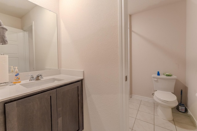 bathroom featuring tile patterned flooring, vanity, and toilet