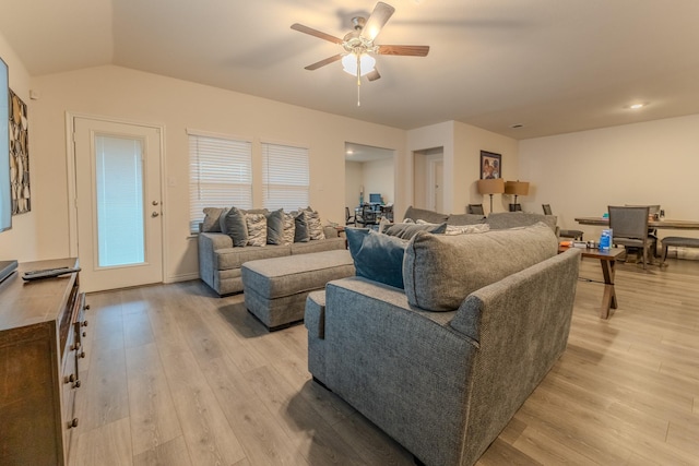 living room with lofted ceiling, light hardwood / wood-style floors, and ceiling fan