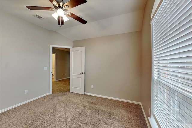 spare room with ceiling fan, carpet flooring, and vaulted ceiling