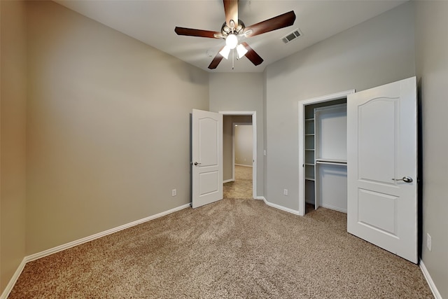 unfurnished bedroom with light colored carpet, a closet, and ceiling fan