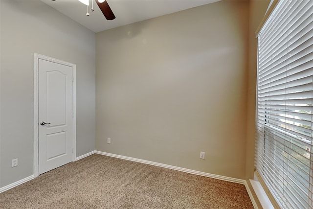 spare room featuring carpet flooring and ceiling fan