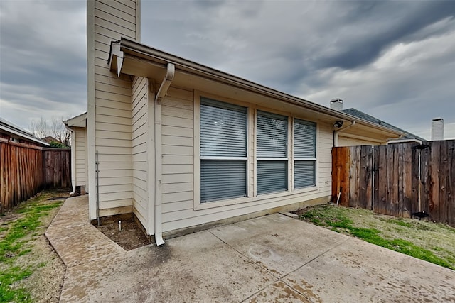 view of side of property with a patio