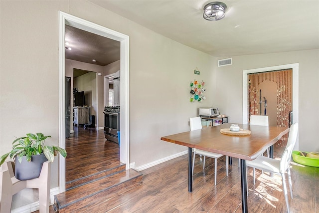 dining area with dark hardwood / wood-style flooring