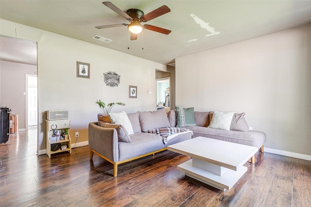 living room with ceiling fan and dark hardwood / wood-style flooring