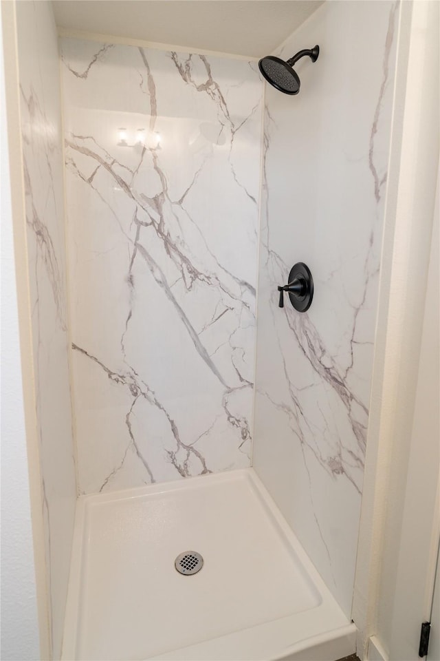 bathroom with tiled shower