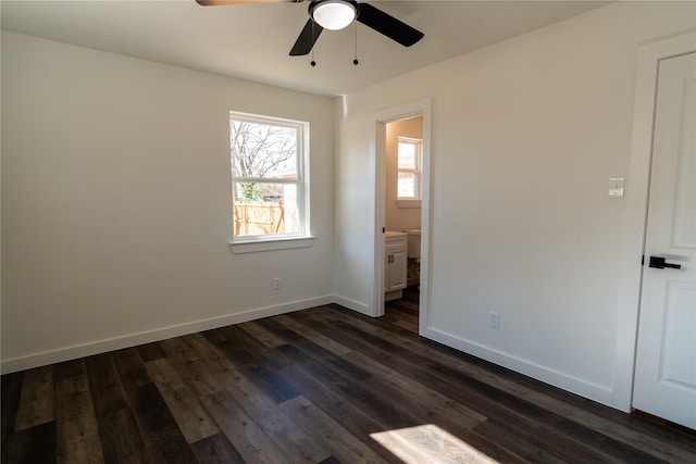 unfurnished bedroom featuring dark wood-type flooring, ceiling fan, and ensuite bathroom