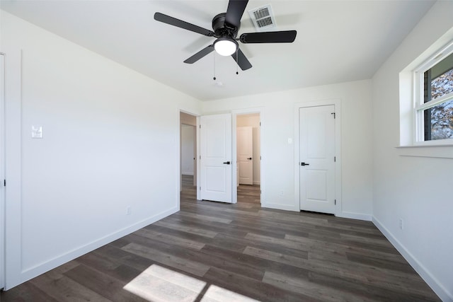 unfurnished bedroom featuring dark hardwood / wood-style floors and ceiling fan