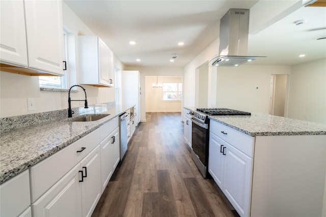 kitchen featuring sink, appliances with stainless steel finishes, light stone counters, island range hood, and white cabinets