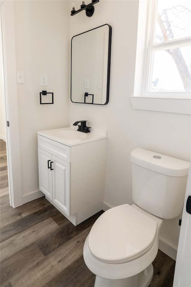 bathroom with vanity, hardwood / wood-style floors, and toilet