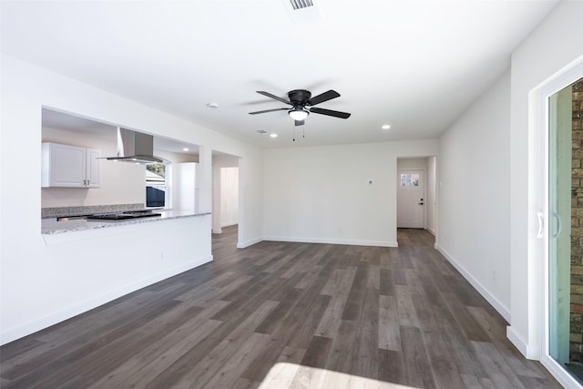 unfurnished living room featuring dark hardwood / wood-style flooring and ceiling fan