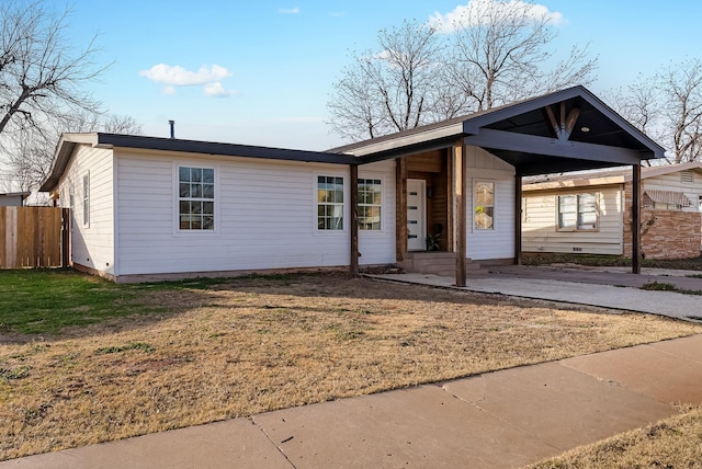 ranch-style house with a front yard and a carport