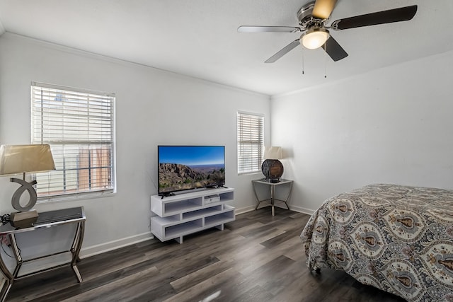 bedroom featuring dark hardwood / wood-style flooring, crown molding, and ceiling fan