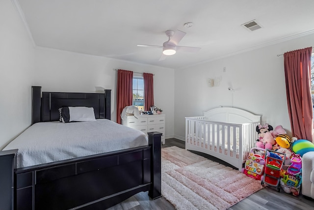 bedroom featuring wood-type flooring, ornamental molding, and ceiling fan