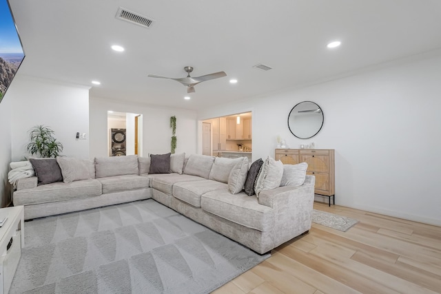 living room featuring ceiling fan and light hardwood / wood-style flooring