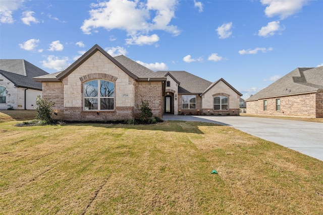 french provincial home with a front lawn