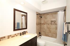 full bathroom featuring toilet, vanity, and shower / bathtub combination with curtain