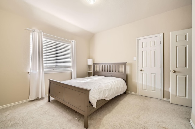 carpeted bedroom with vaulted ceiling