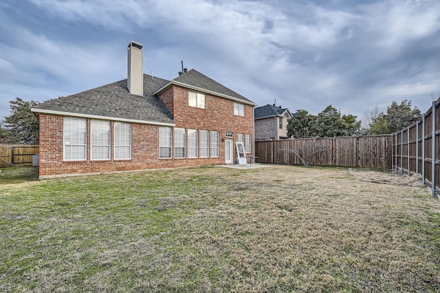 rear view of house with a yard and a patio area