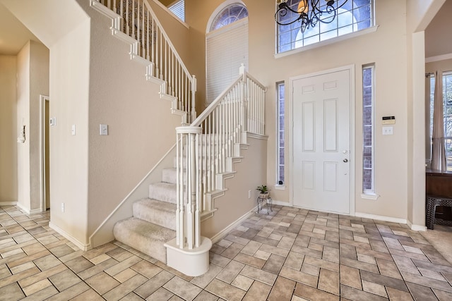 entrance foyer with an inviting chandelier and a high ceiling