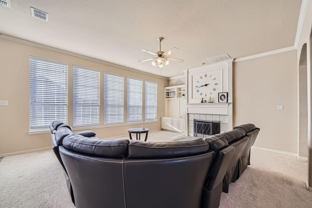 living room with ornamental molding, light carpet, and a fireplace