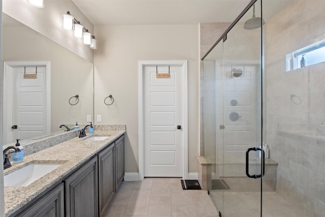 bathroom with tile patterned floors, vanity, and a shower with door