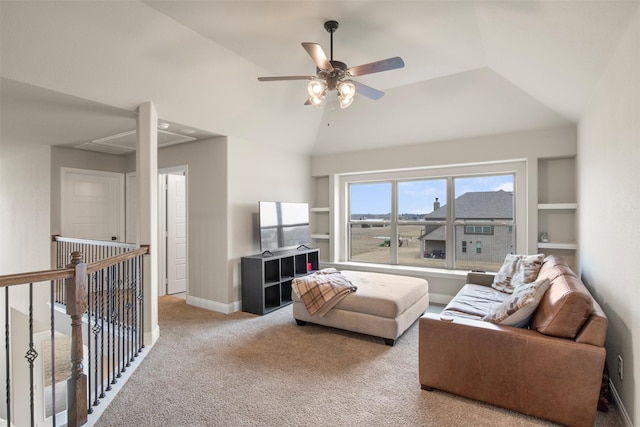 carpeted living room with built in shelves, ceiling fan, and lofted ceiling