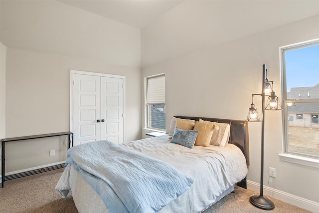 carpeted bedroom featuring lofted ceiling and a closet