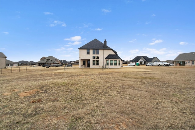 rear view of house with a yard