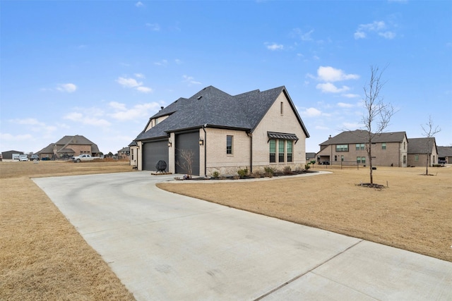 view of home's exterior with a garage and a lawn