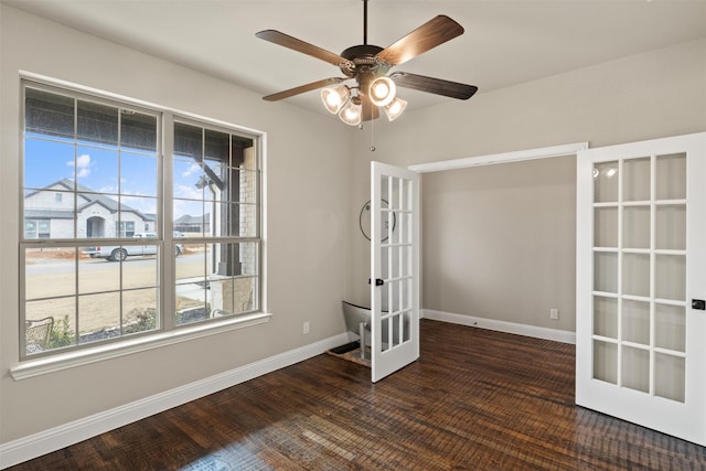 unfurnished room featuring dark hardwood / wood-style flooring, french doors, and ceiling fan