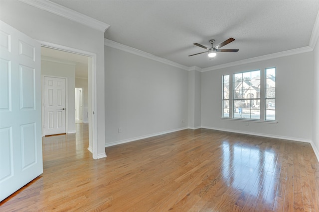 empty room featuring ceiling fan, ornamental molding, a textured ceiling, and light wood-type flooring