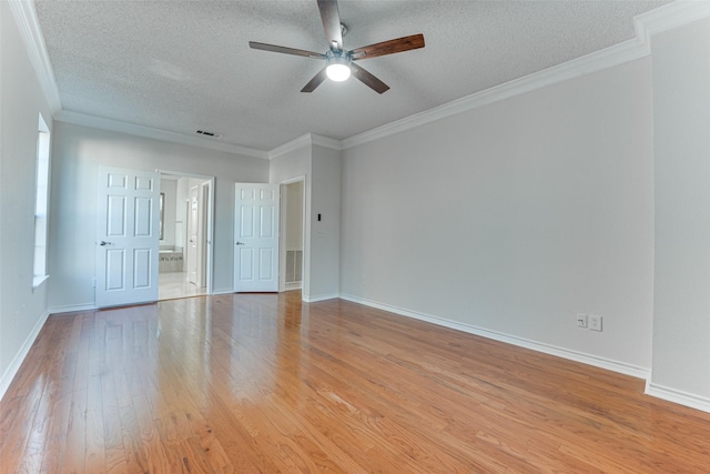 spare room featuring ceiling fan, ornamental molding, a textured ceiling, and light wood-type flooring