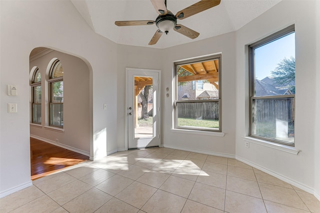 tiled entryway with ceiling fan, plenty of natural light, and a mountain view